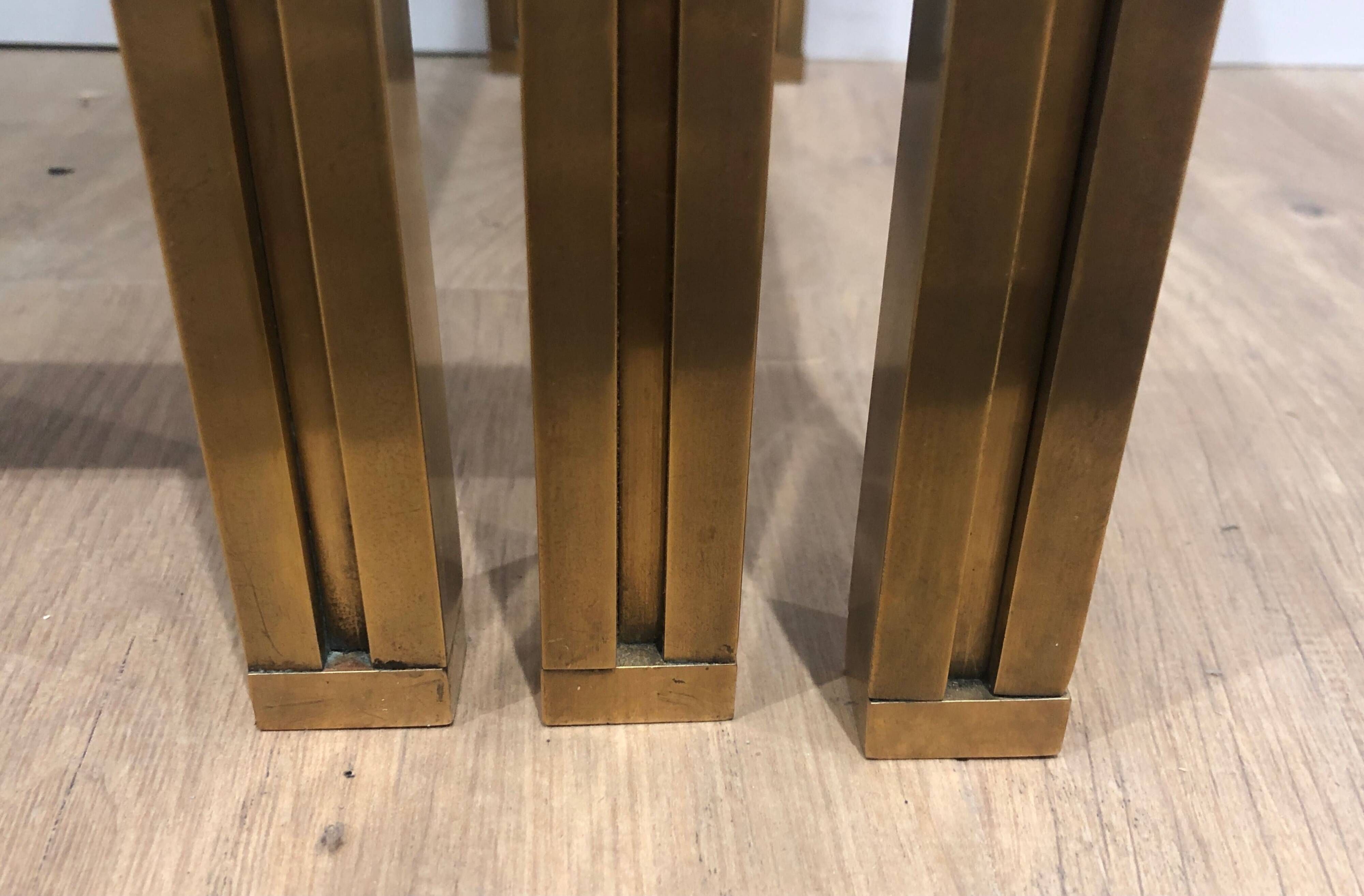 Set of 3 nesting tables in brass and glass. French work by Guy Lef.