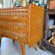 Vintage wooden and rattan chest of drawers with tapered legs.