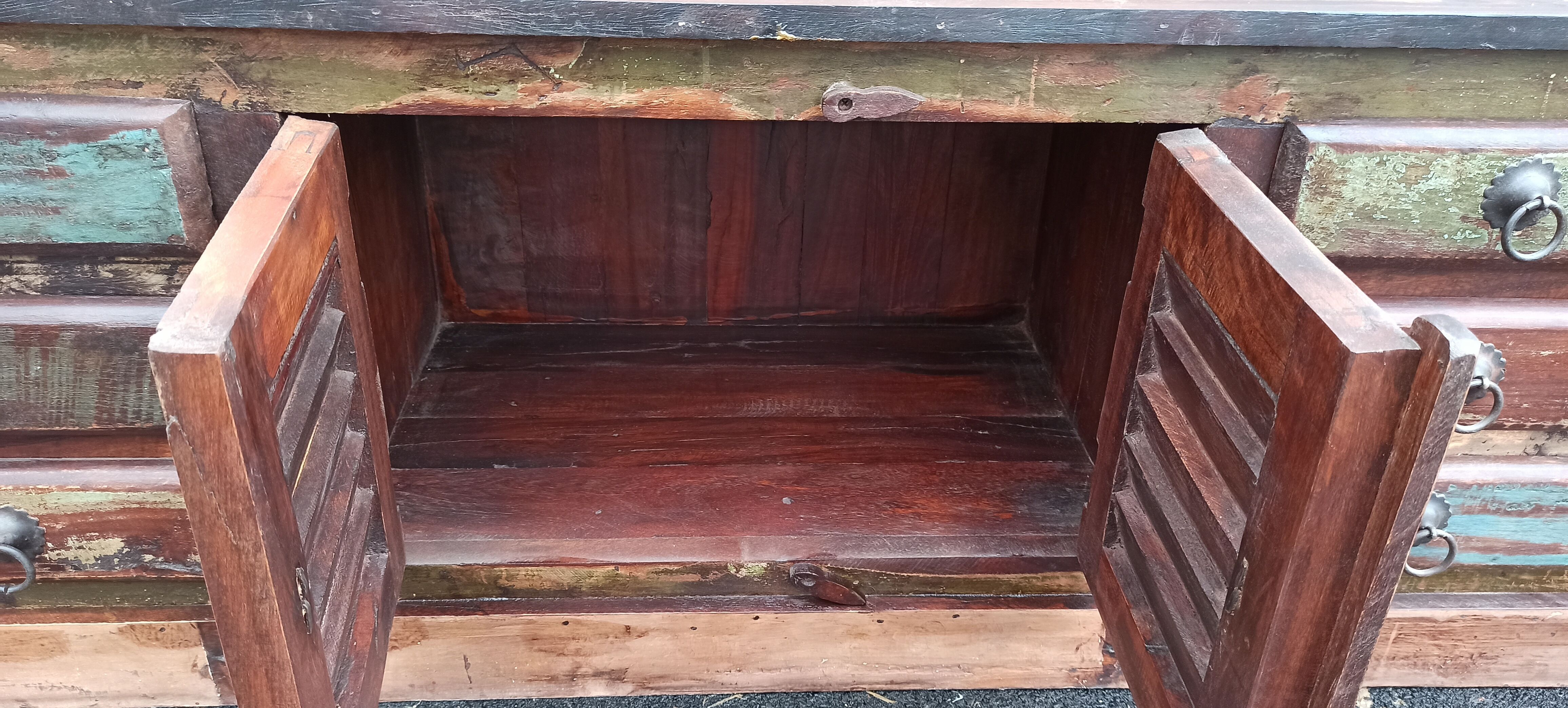 Furniture low in colorful wood. 12 drawers and 1 door