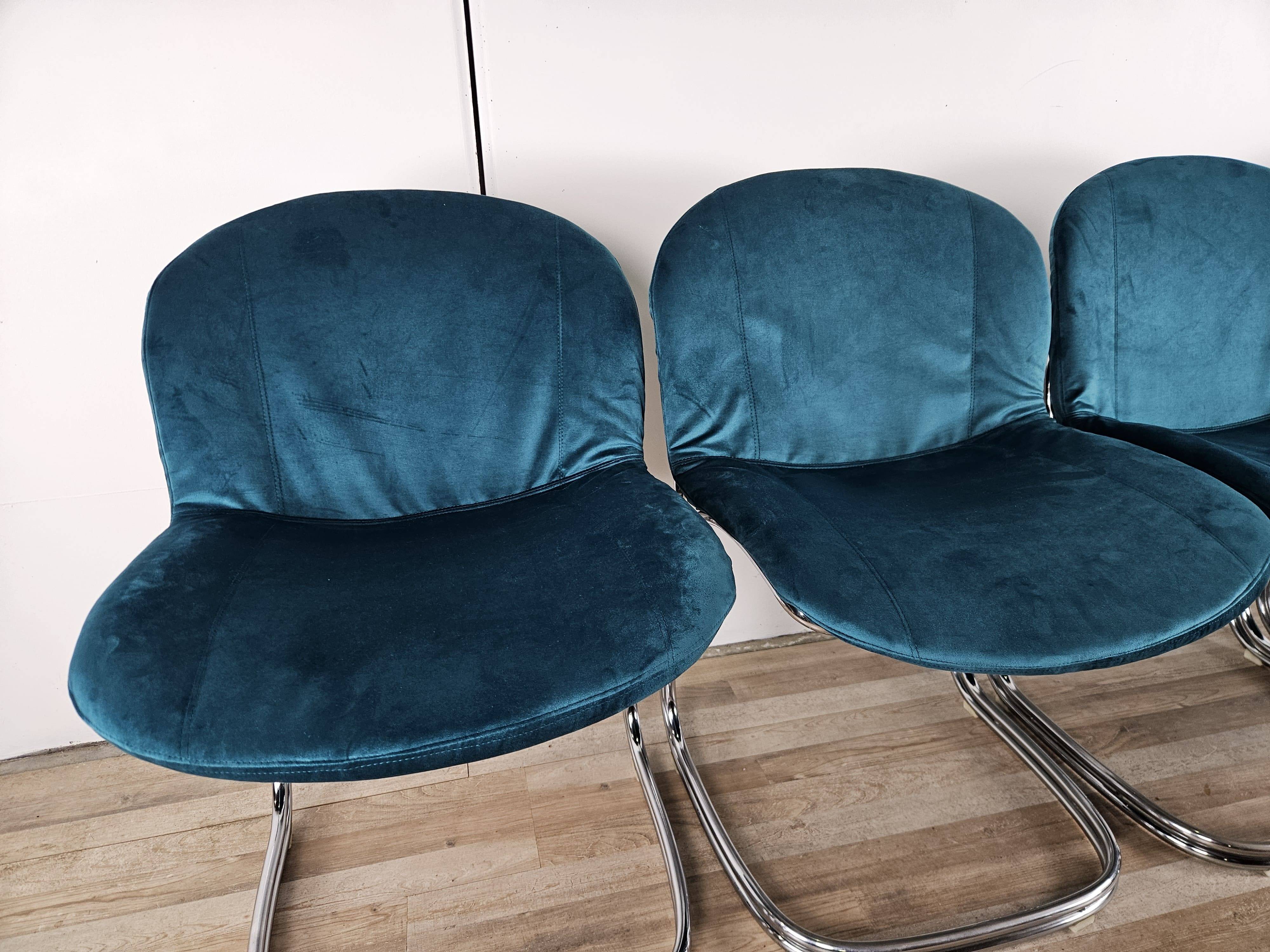 Four 1970s tubular chairs upholstered in blue velvet