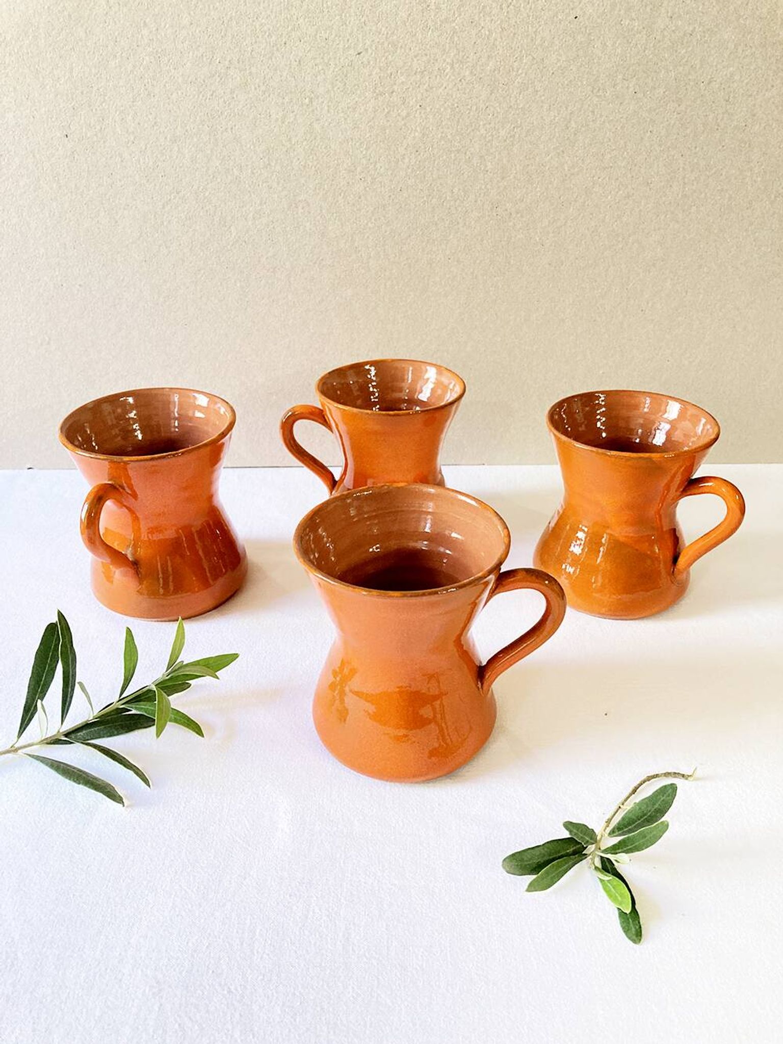 4 large orange enameled ceramic cups, signed