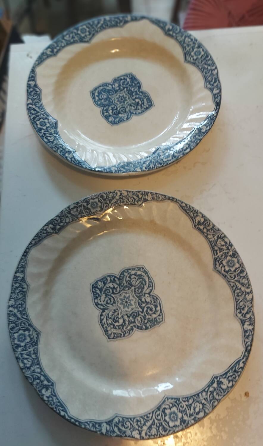 Two antique 19th-century plates, one flat and one deep, from Gien.
