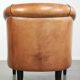 Vintage sheepskin club armchair with a warm colour scheme with black piping