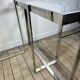 Chrome metal and glass console from the 2000s.