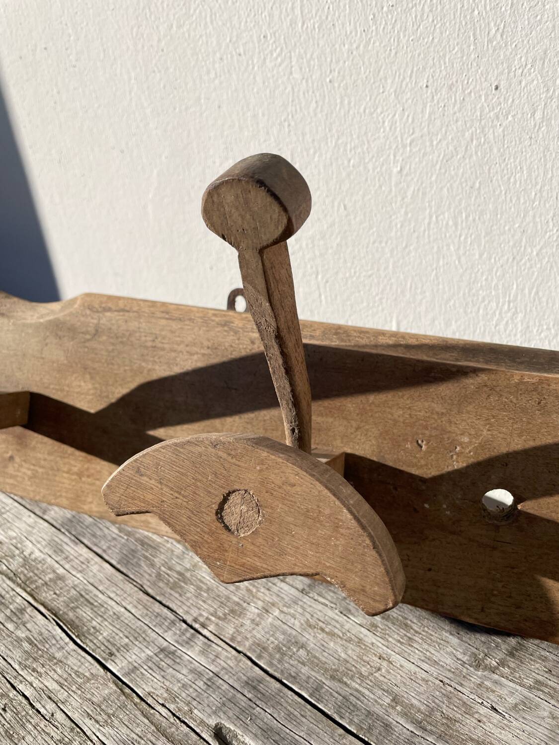 Wooden wall-mounted coat rack