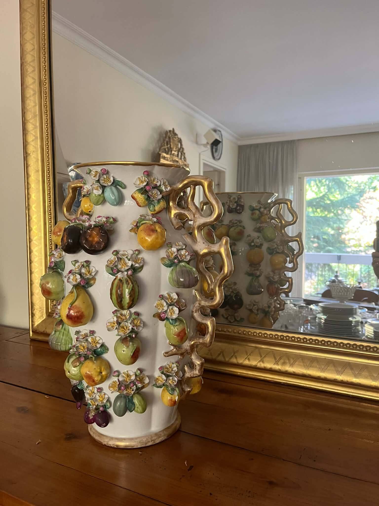 Large antique vase with relief decorations of coloured fruits.