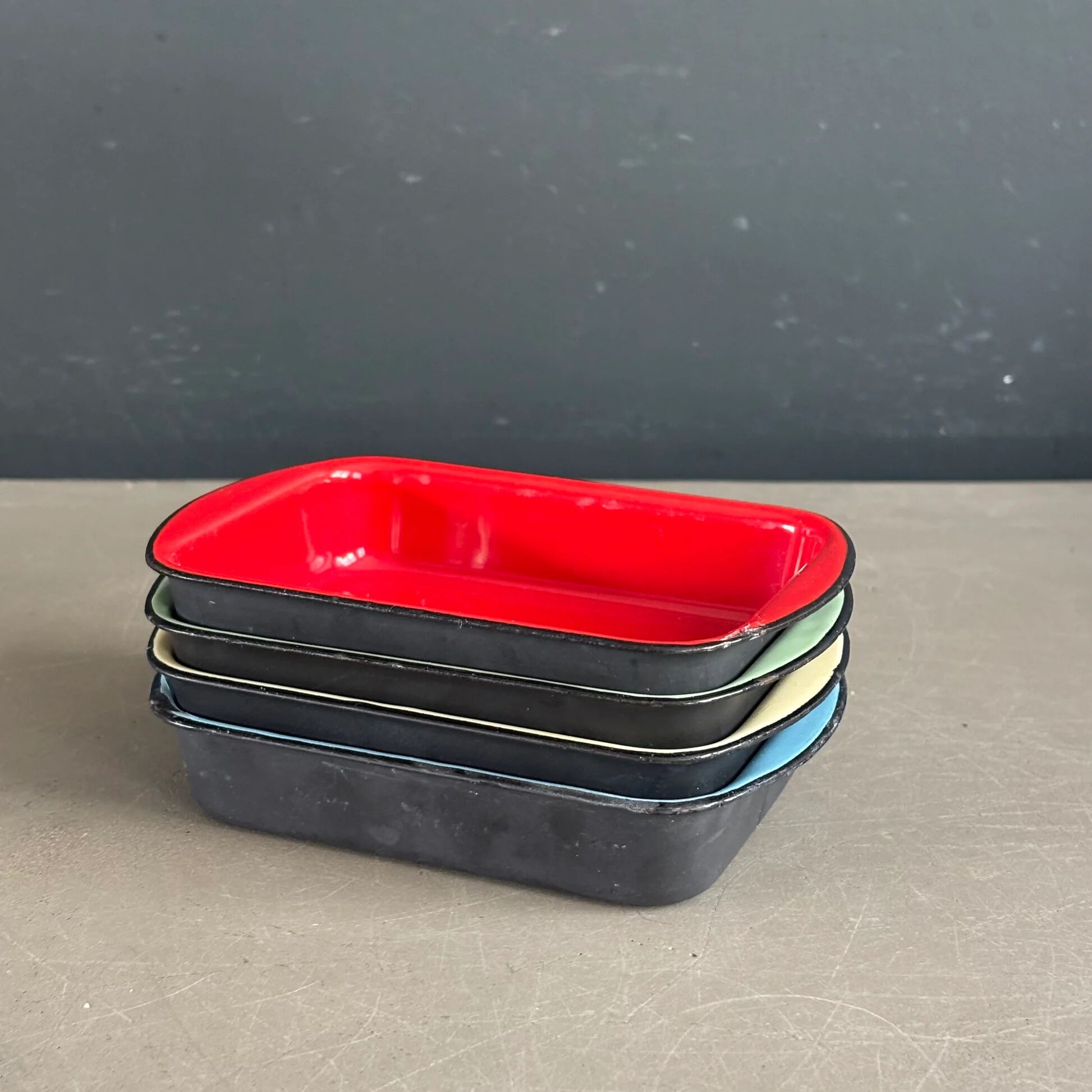 Set of 4 enamelled cast iron dishes/platters.