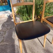 3 Scandinavian style chairs, light wood and black faux leather.