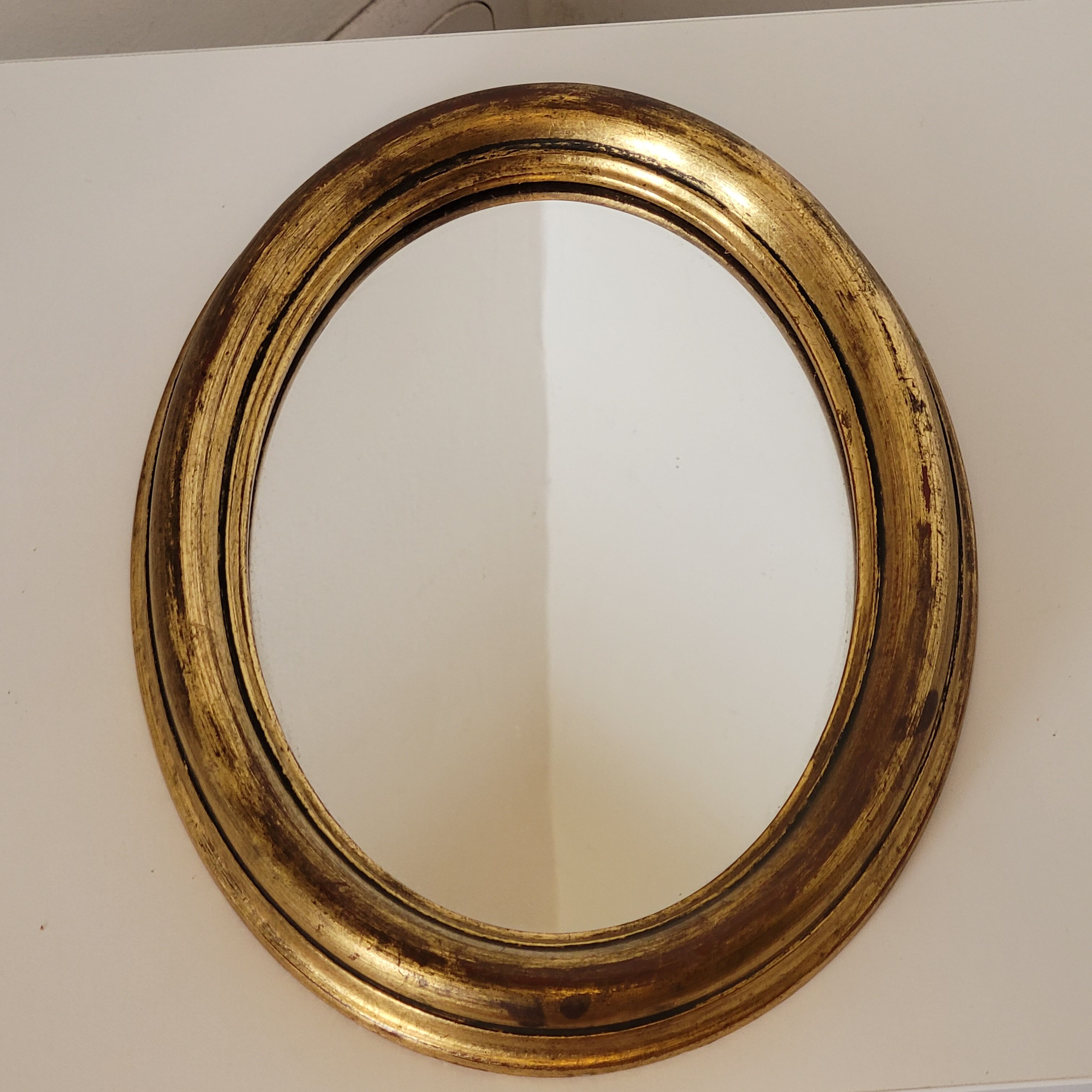 Old small oval mirror gilded wooden frame 22 X 17 X 2 cm.