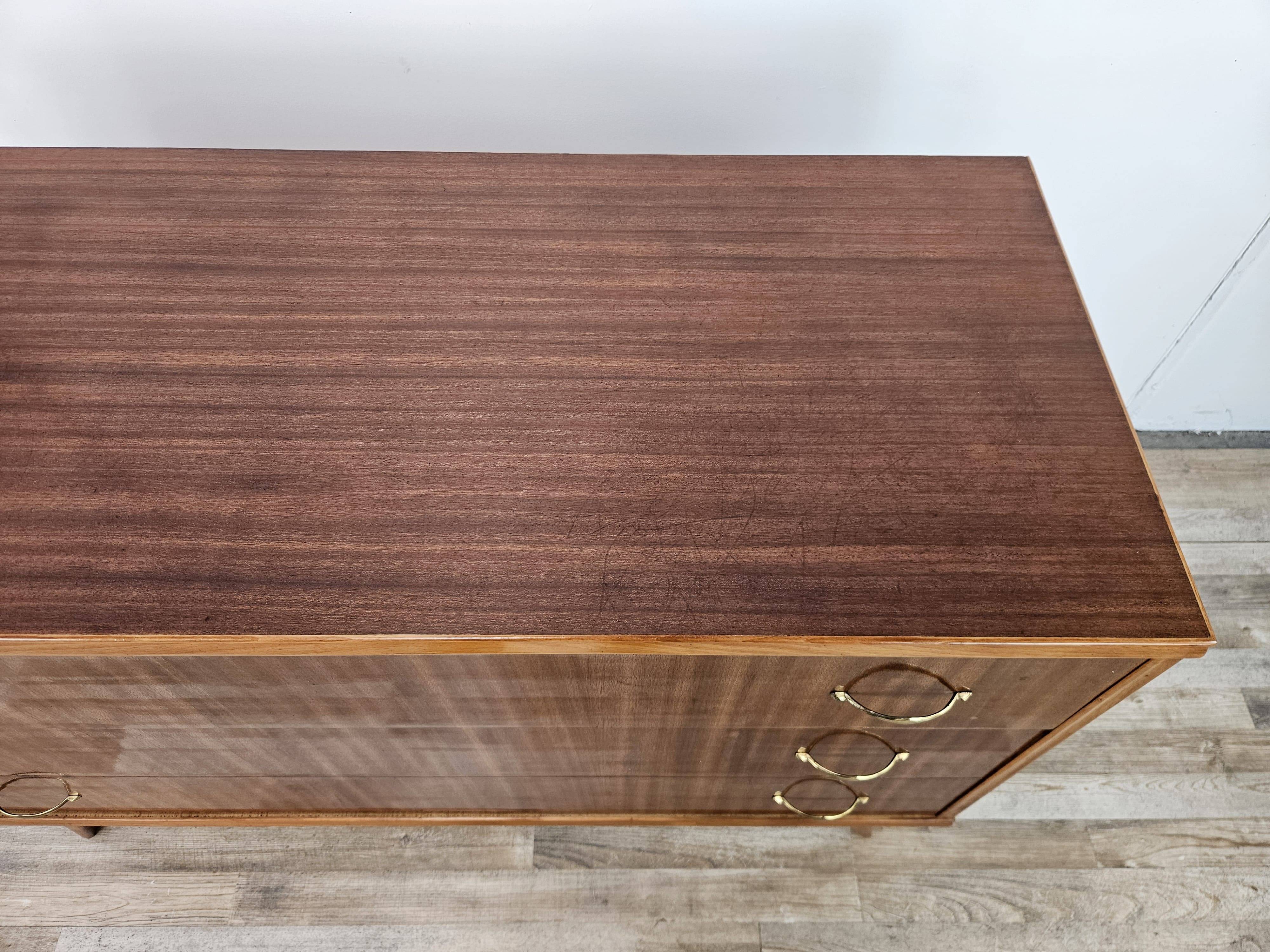 1950s chest of drawers covered in walnut with brass handles