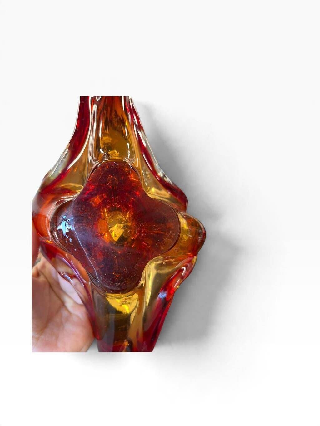 Vintage Murano glass bowl/plate in orange-red with swirling patterns.
