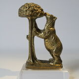 Brass sculpture, bear looking for honey in the tree