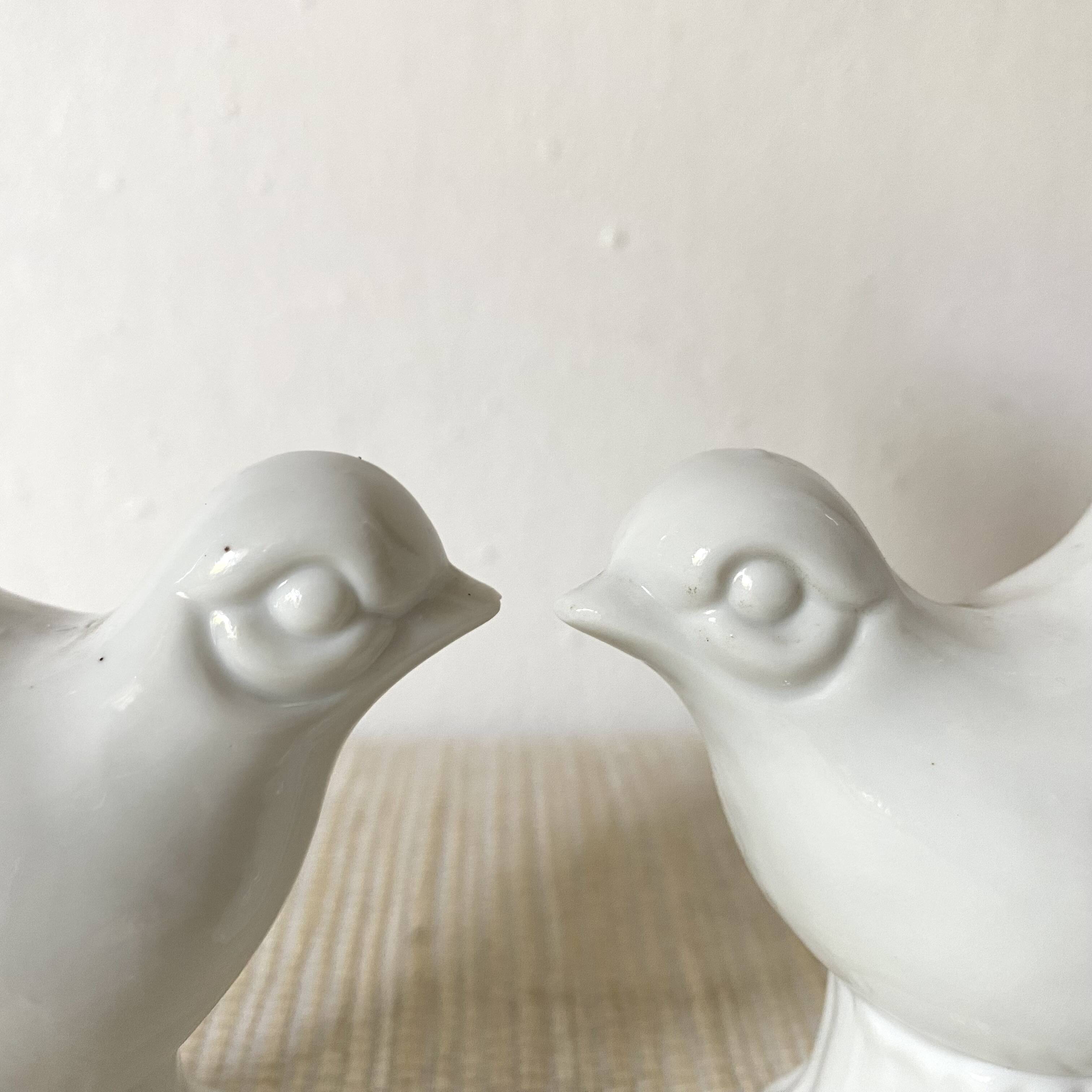Pair of porcelain candle holders and bird vases