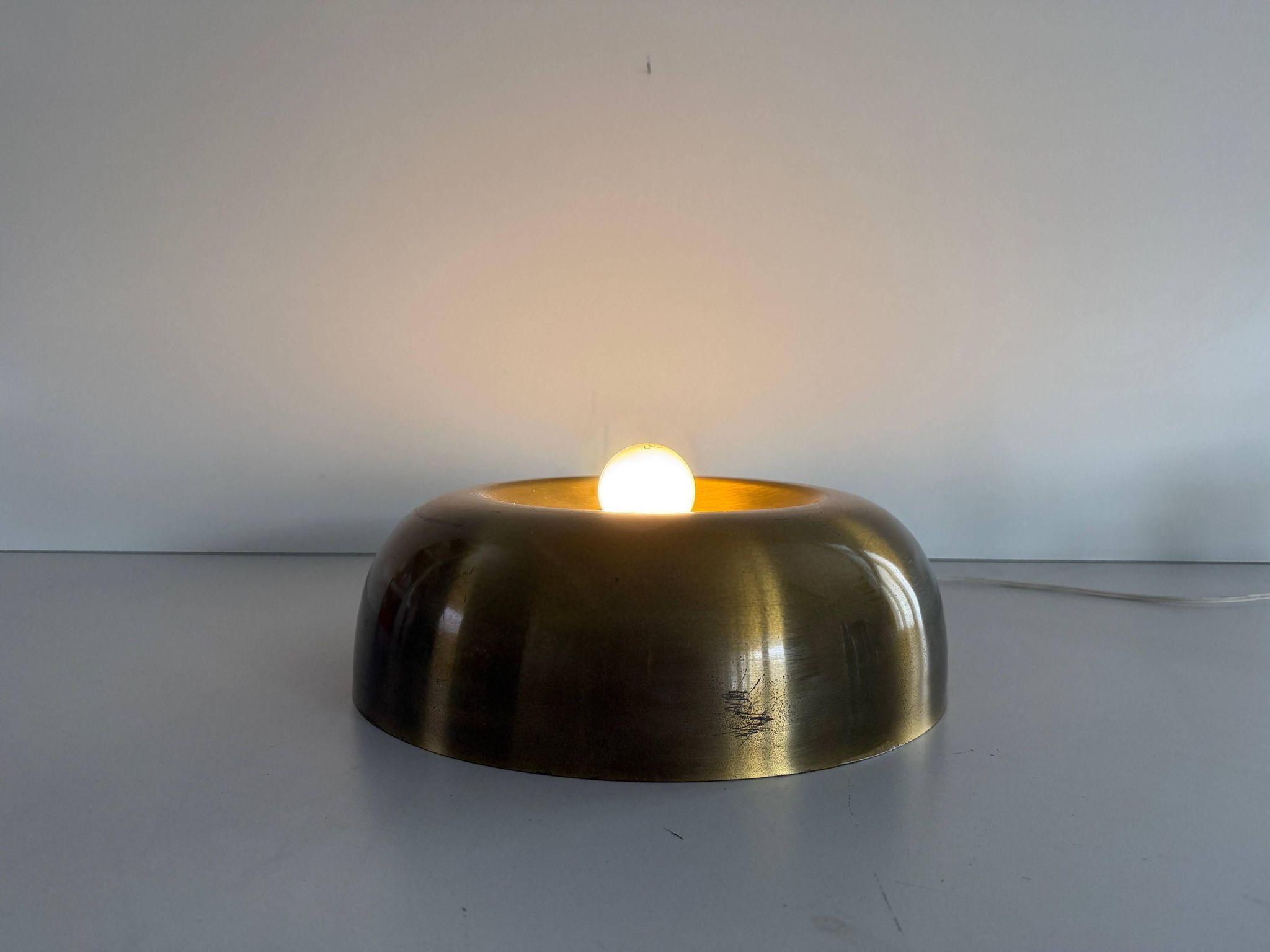Flush-mounted disc-shaped brass fixture from the mid-century, 1960, Italy.