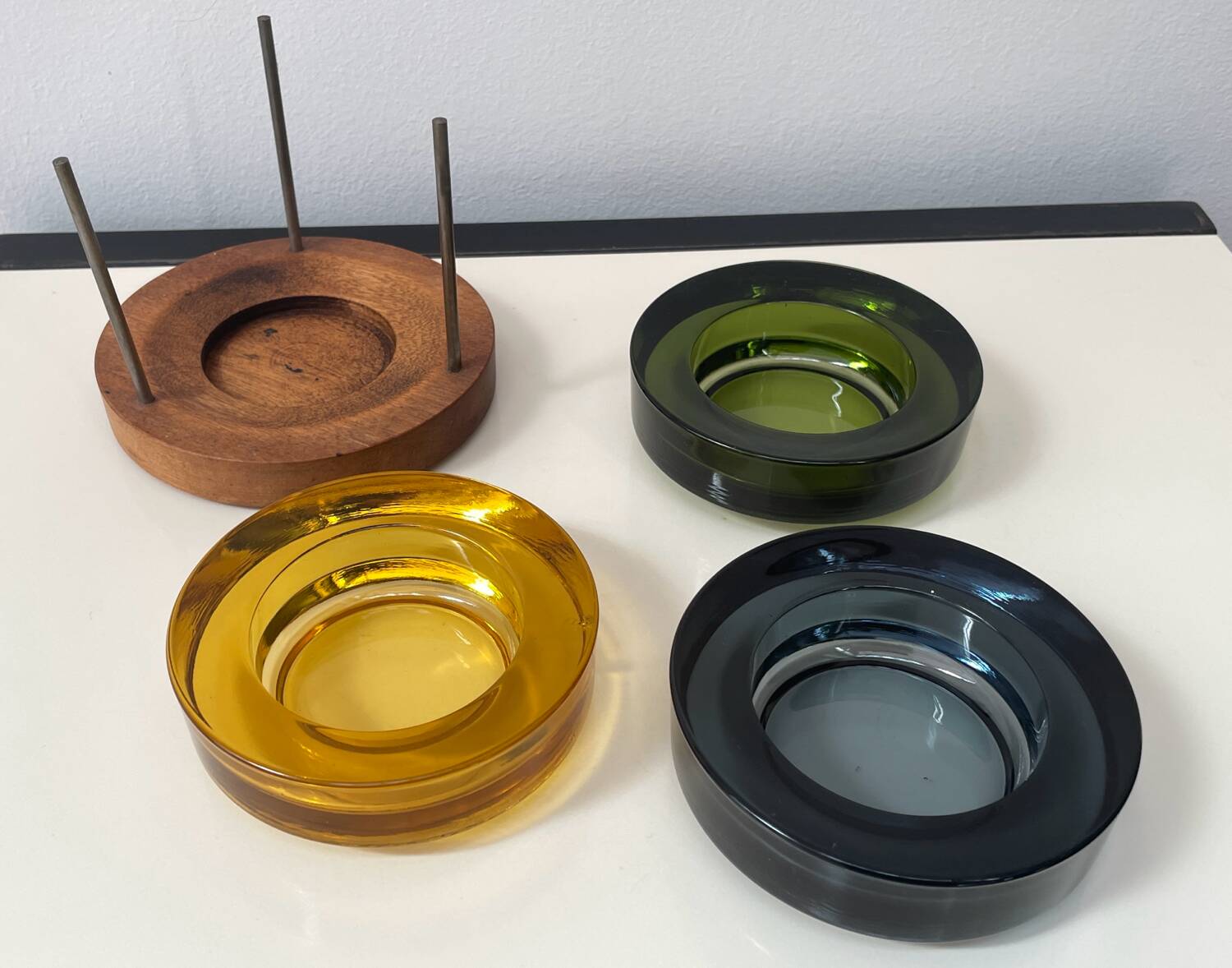 Set of 3 stackable glass catchalls with a teak base.
