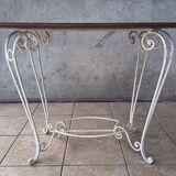 Wrought iron table with a walnut top.