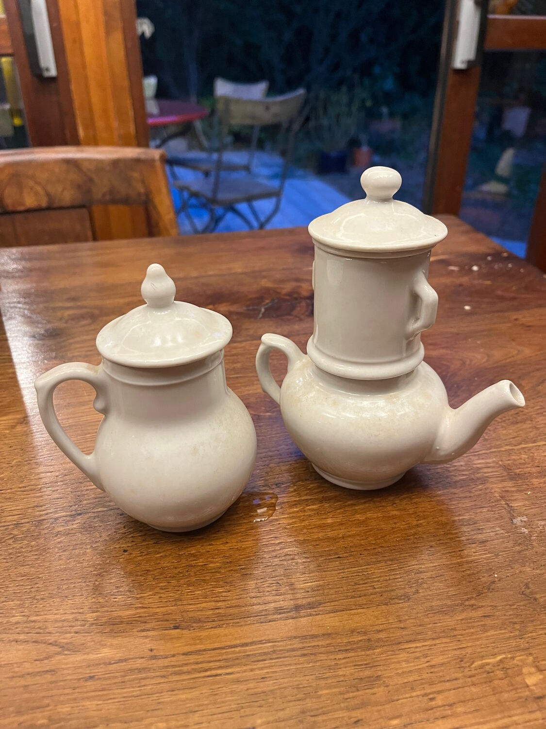 Antique white earthenware teapot, individual service with filter.