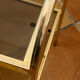 Gold metal and smoked glass console table.