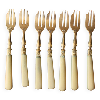 Set of 7 small golden bakelite dessert forks