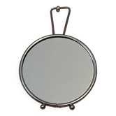Small round barber-style mirror.