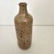 Pyrite stoneware single-flower vase in the shape of a bottle signed Aular?