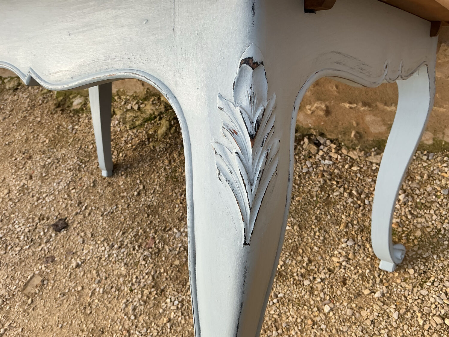 Louis XV style walnut table with a natural wood top.