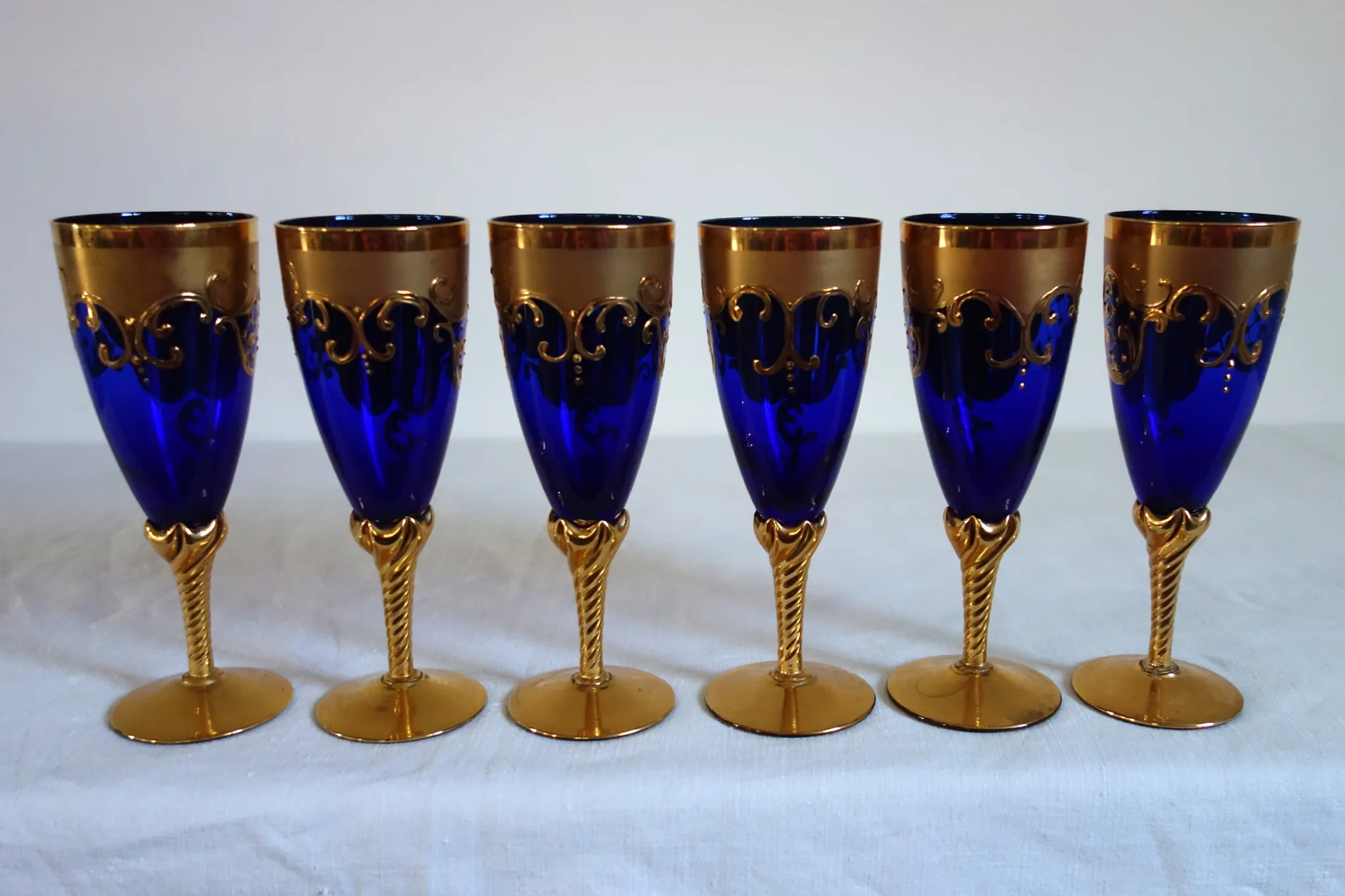 12 cobalt blue and gold Murano glass flutes, mid-20th century.