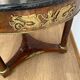 Empire gueridon in mahogany veneer adorned with chiselled and gilded bronze, topped with black marble with a groove.