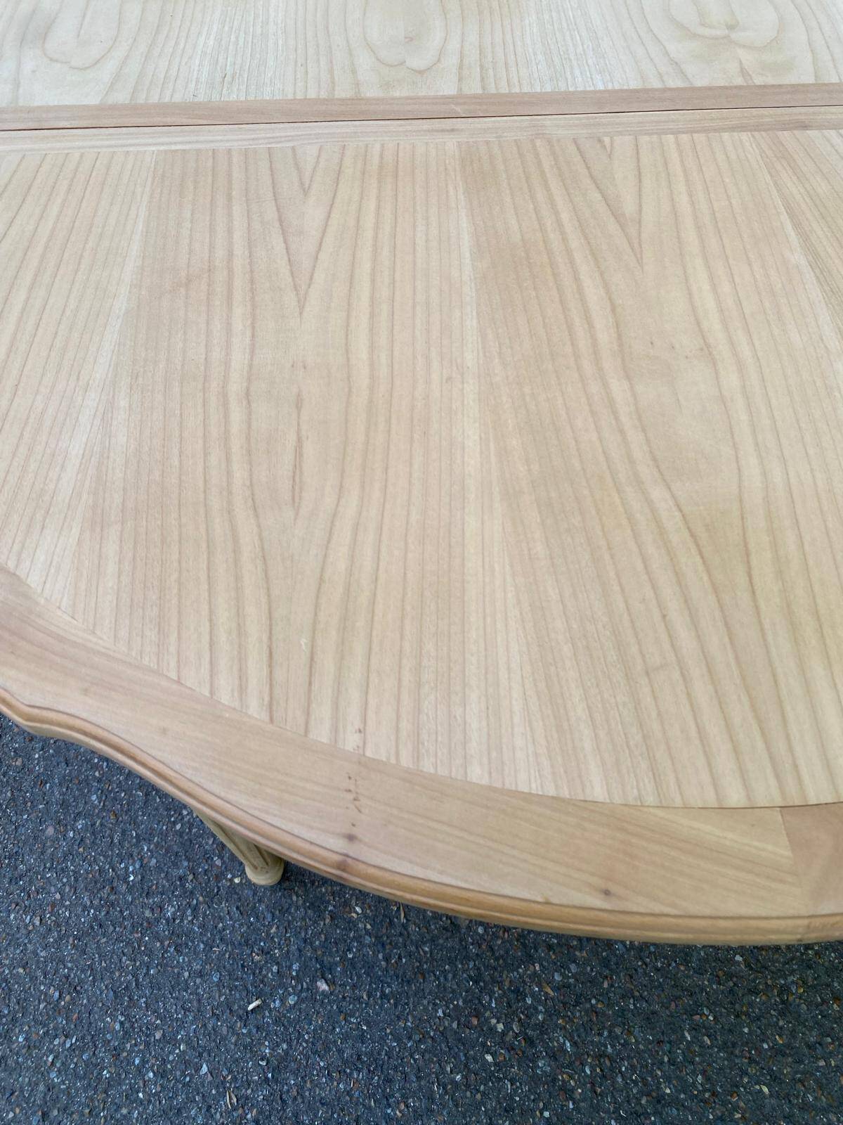 Extendable round table in renovated Louis XVI style, made of light wood, with 2 extensions.