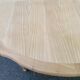 Extendable round table in renovated Louis XVI style, made of light wood, with 2 extensions.