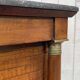 Empire bedside table from the 19th century in cherry wood and black marble.