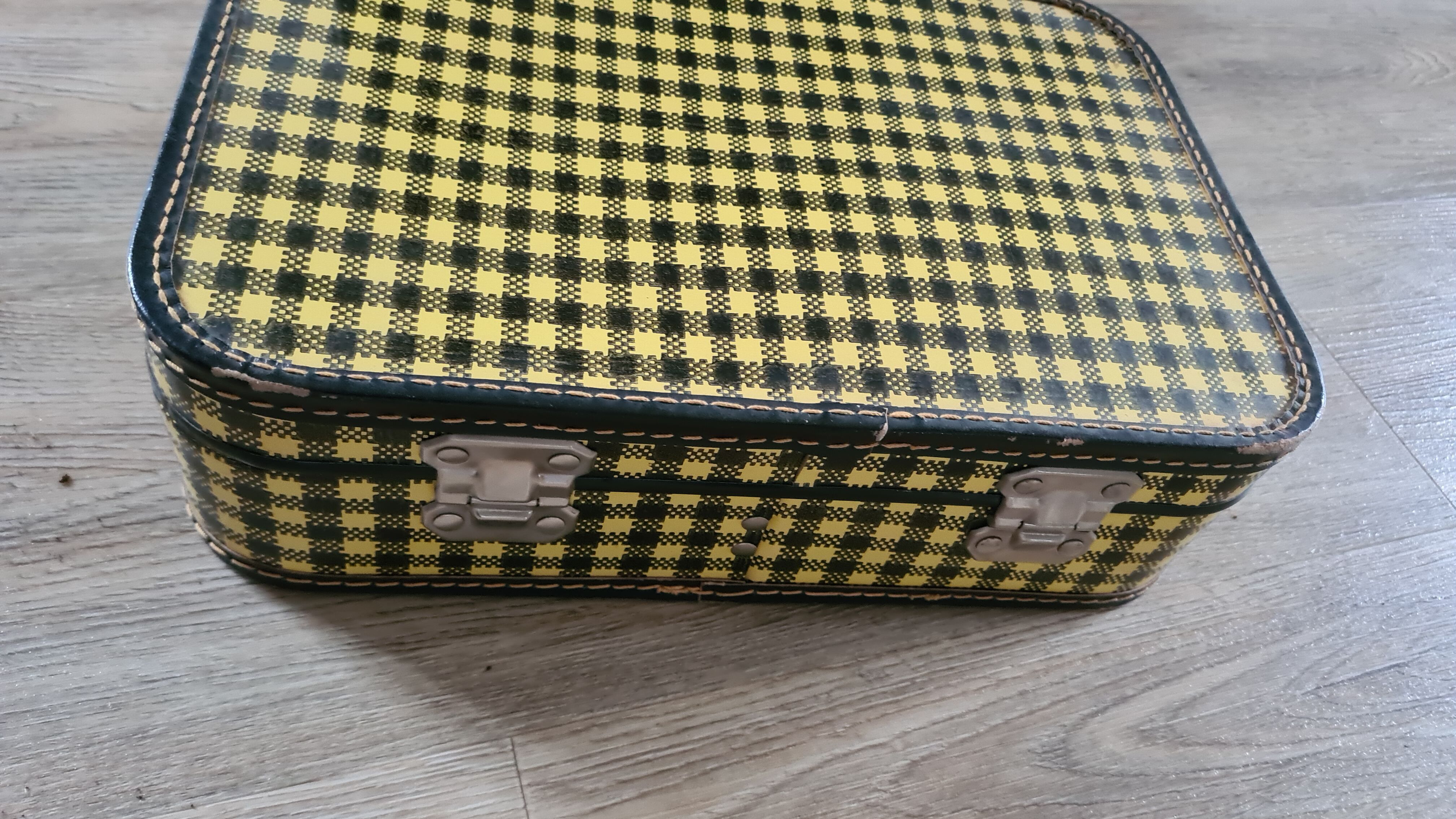 Antique suitcase in vintage yellow and black cardboard