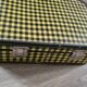 Antique suitcase in vintage yellow and black cardboard