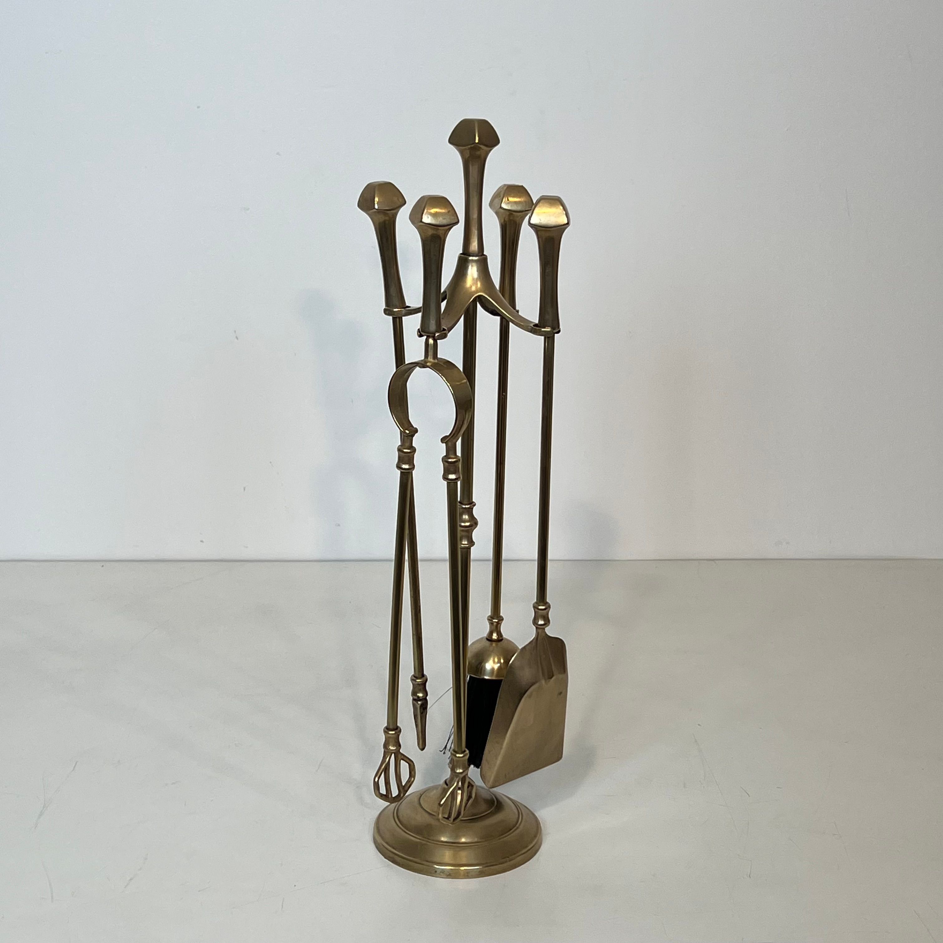 Neoclassical brass fire accessory.