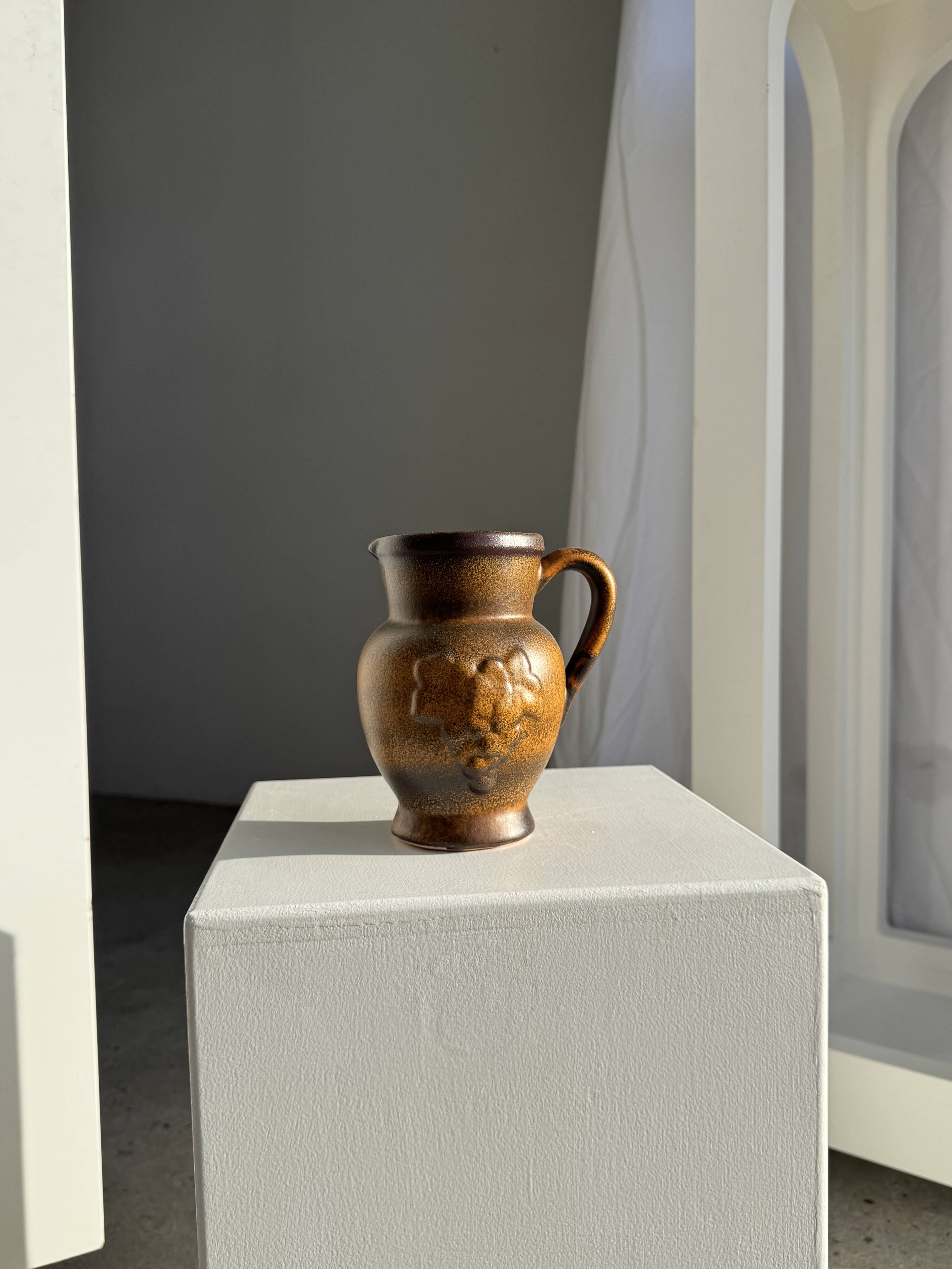 Speckled stoneware jug with grape pattern H17