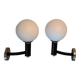 Pair of wall lights in gilded and black lacquered brass, Italy 1970/1980.