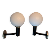 Pair of wall lights in gilded and black lacquered brass, Italy 1970/1980.
