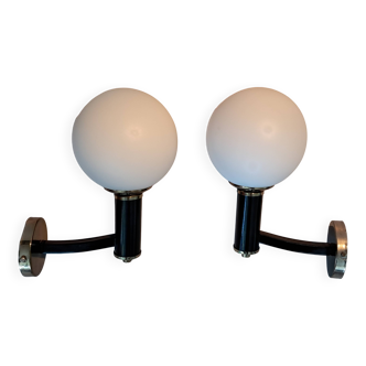 Pair of wall lights in gilded and black lacquered brass, Italy 1970/1980.
