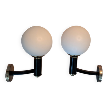 Pair of wall lights in gilded and black lacquered brass, Italy 1970/1980.