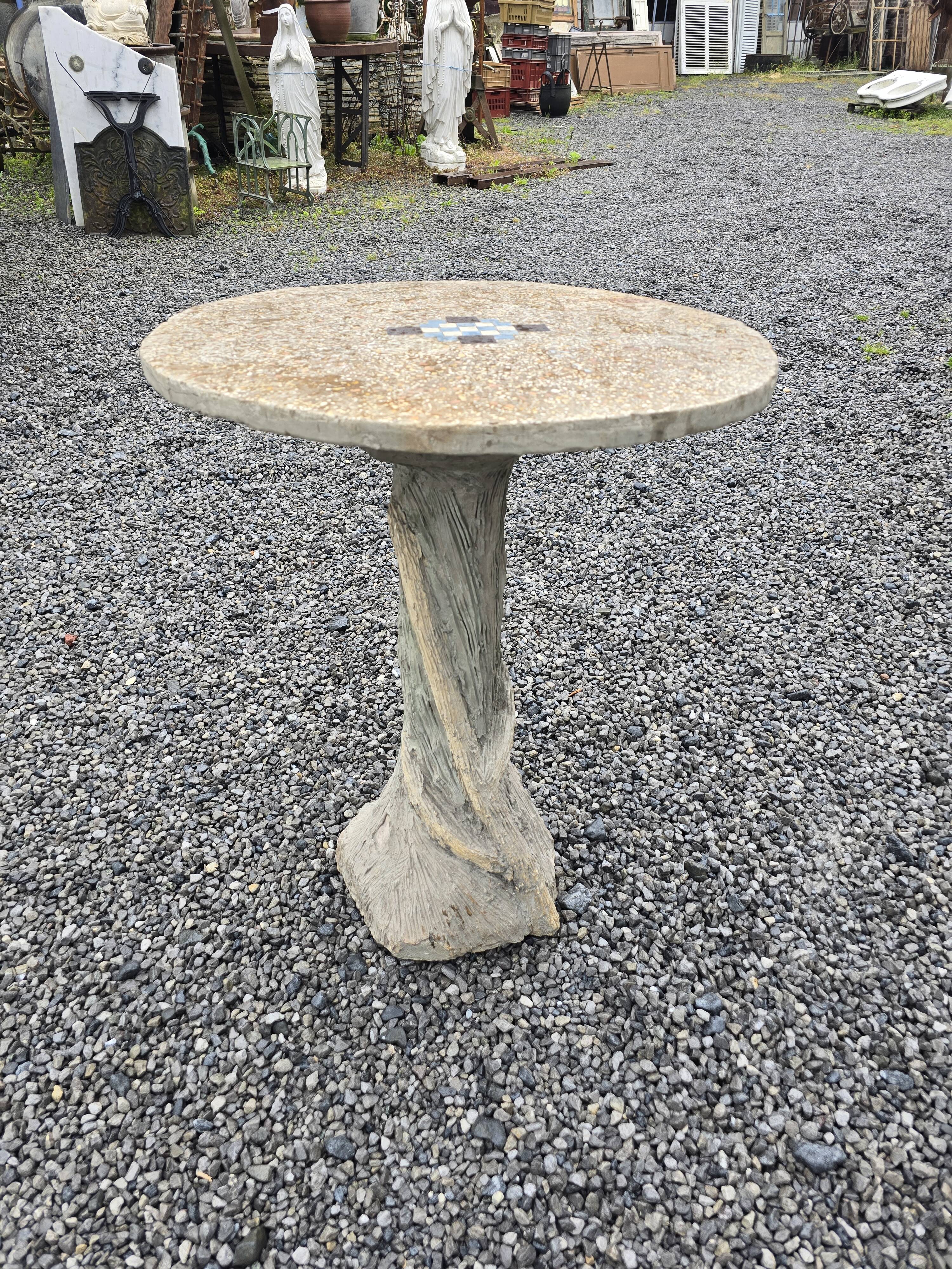Cement garden table with trunk-shaped foot