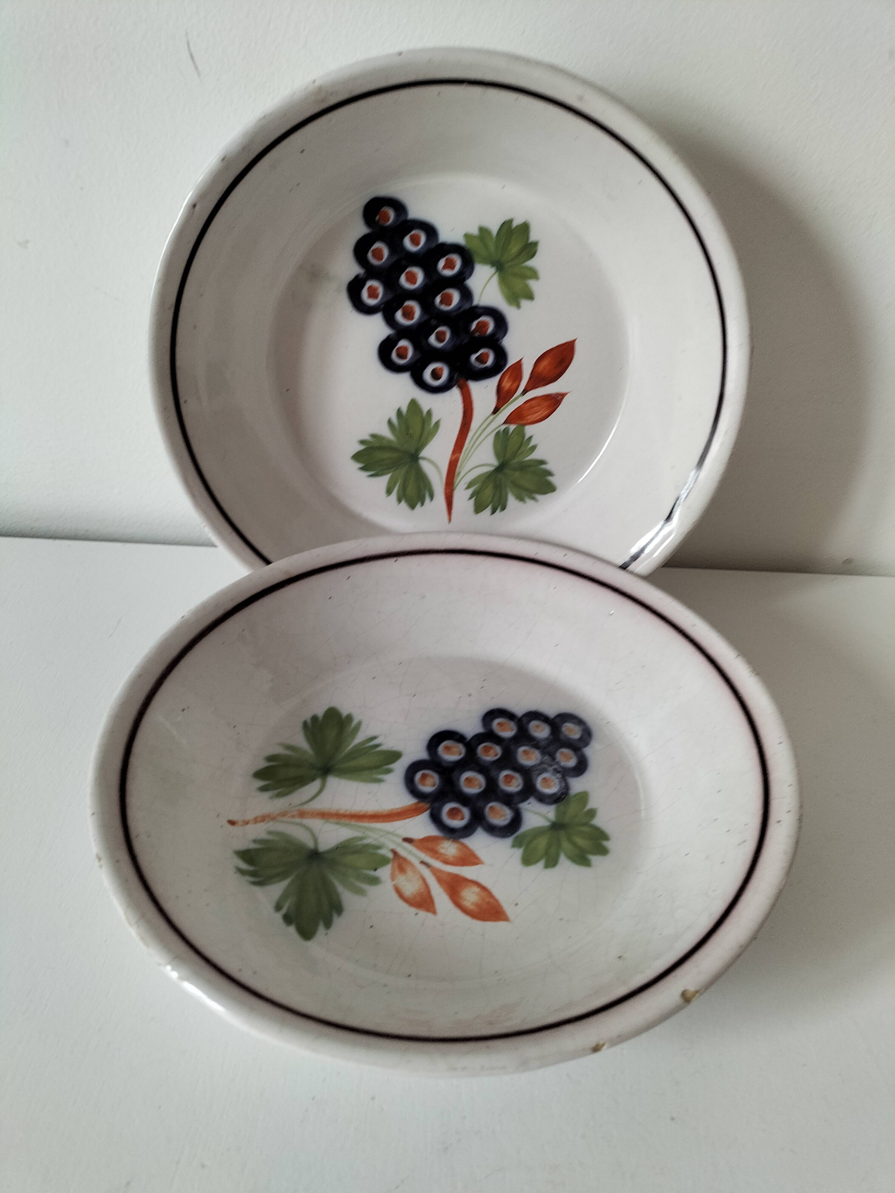 Pair of antique soup plates with hand-painted grape decoration