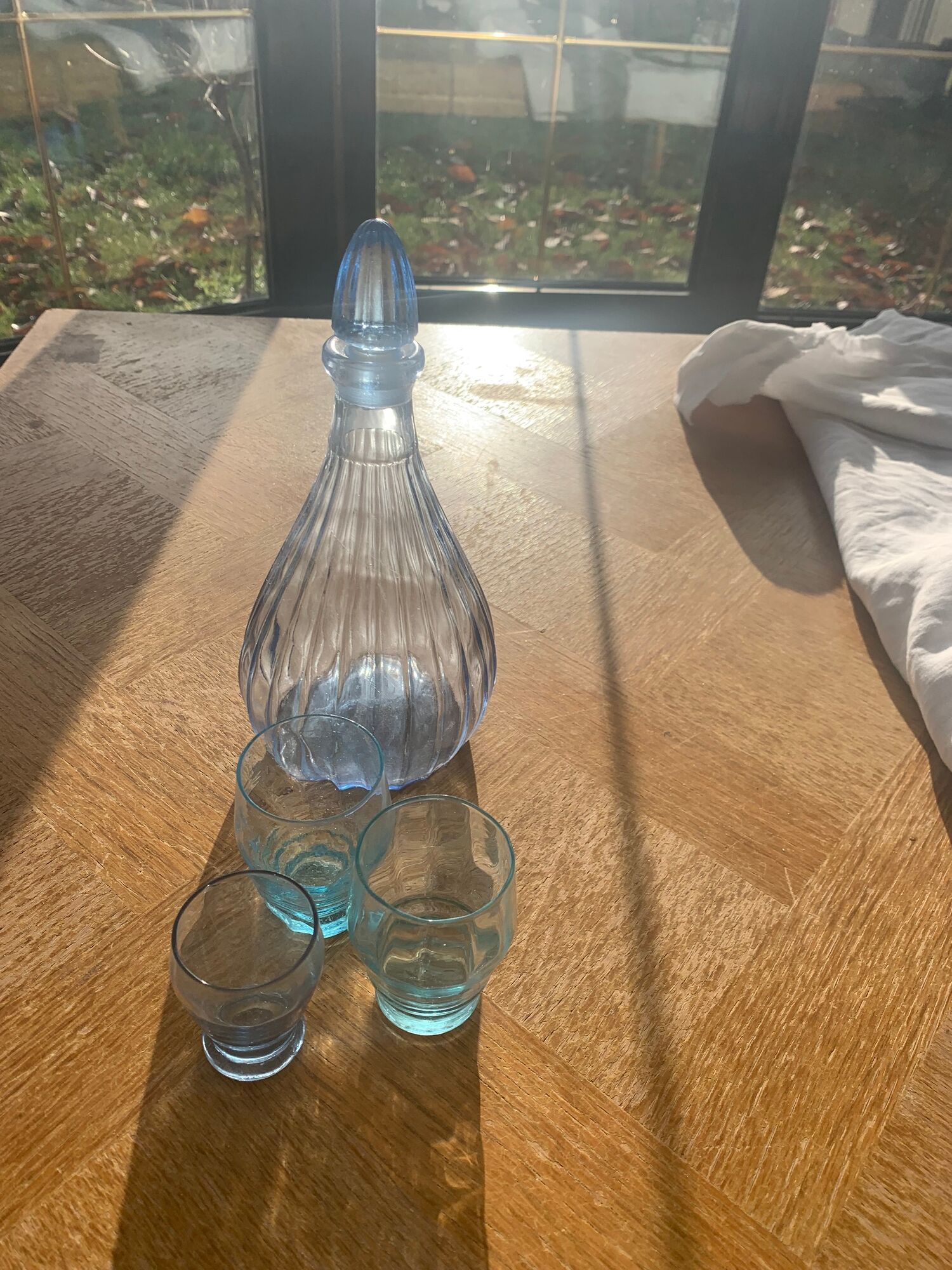 Liquor service consisting of a blue glass decanter and. 3 small antique glasses