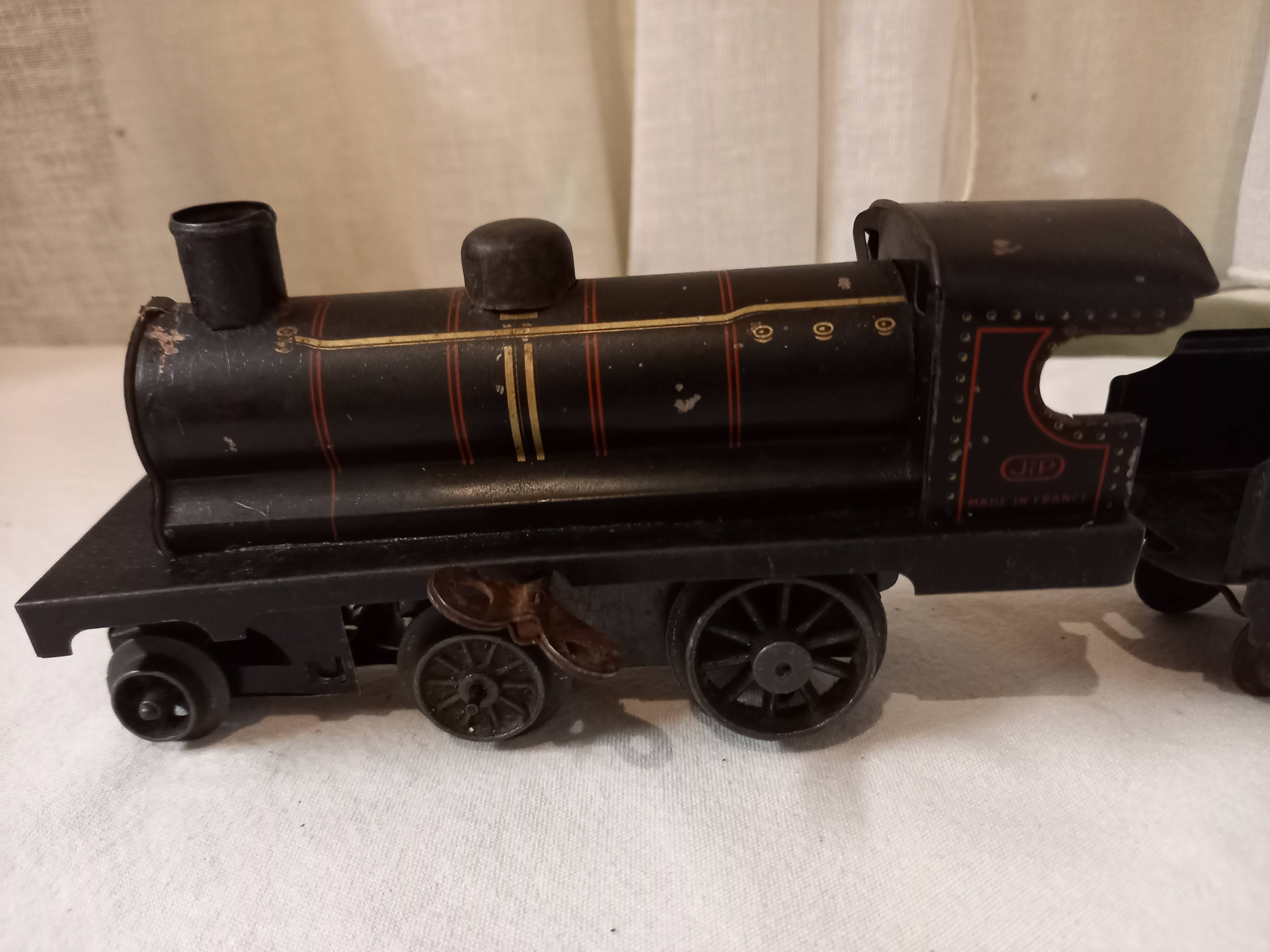 Small JEP mechanical train, including locomotive, tender, sleeping car, rail, 1930s