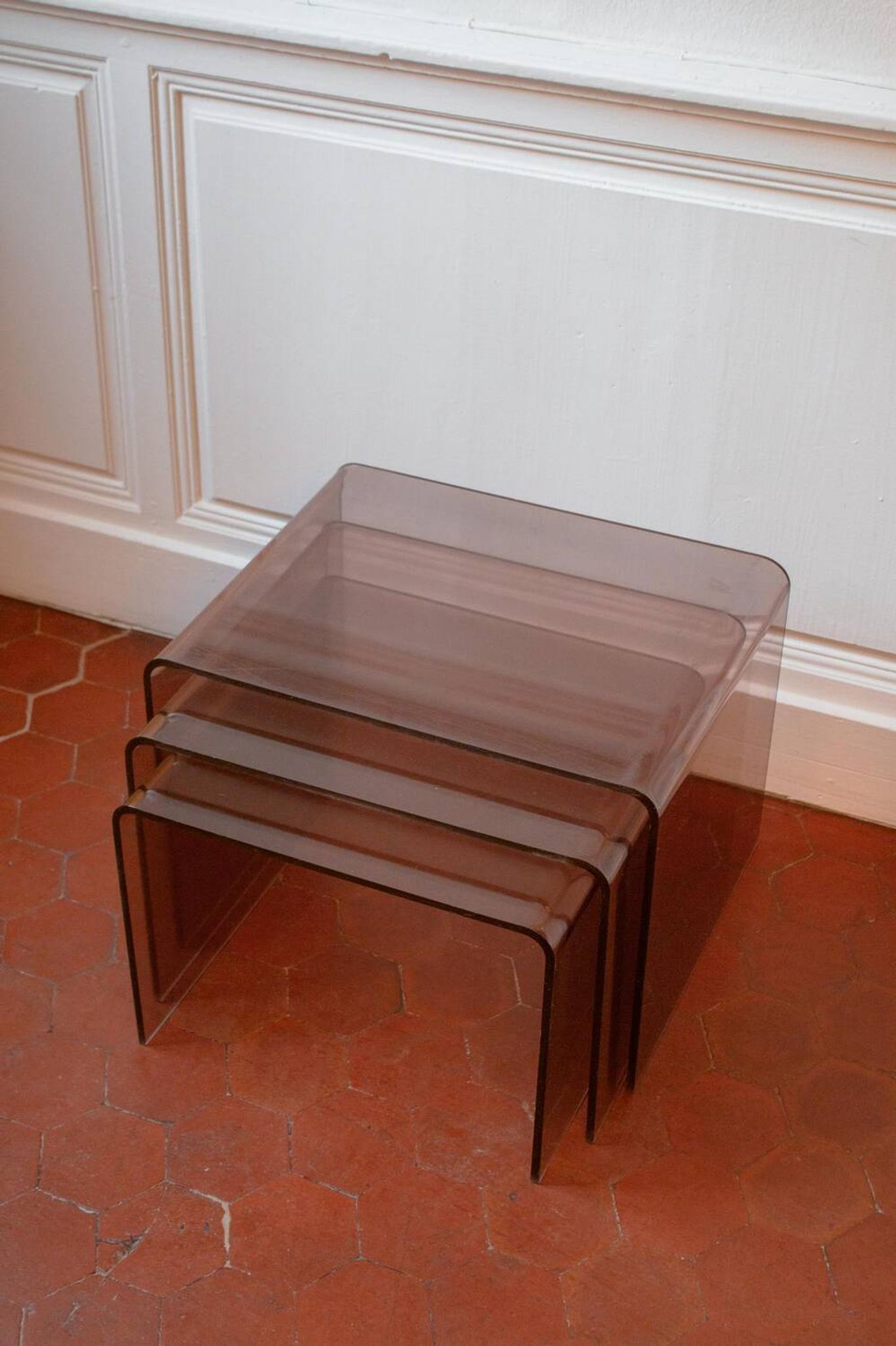 Vintage trio of nesting tables in smoked plexiglass by Michel Dumas, year.