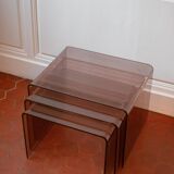 Vintage trio of nesting tables in smoked plexiglass by Michel Dumas, year.