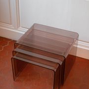 Vintage trio of nesting tables in smoked plexiglass by Michel Dumas, year.