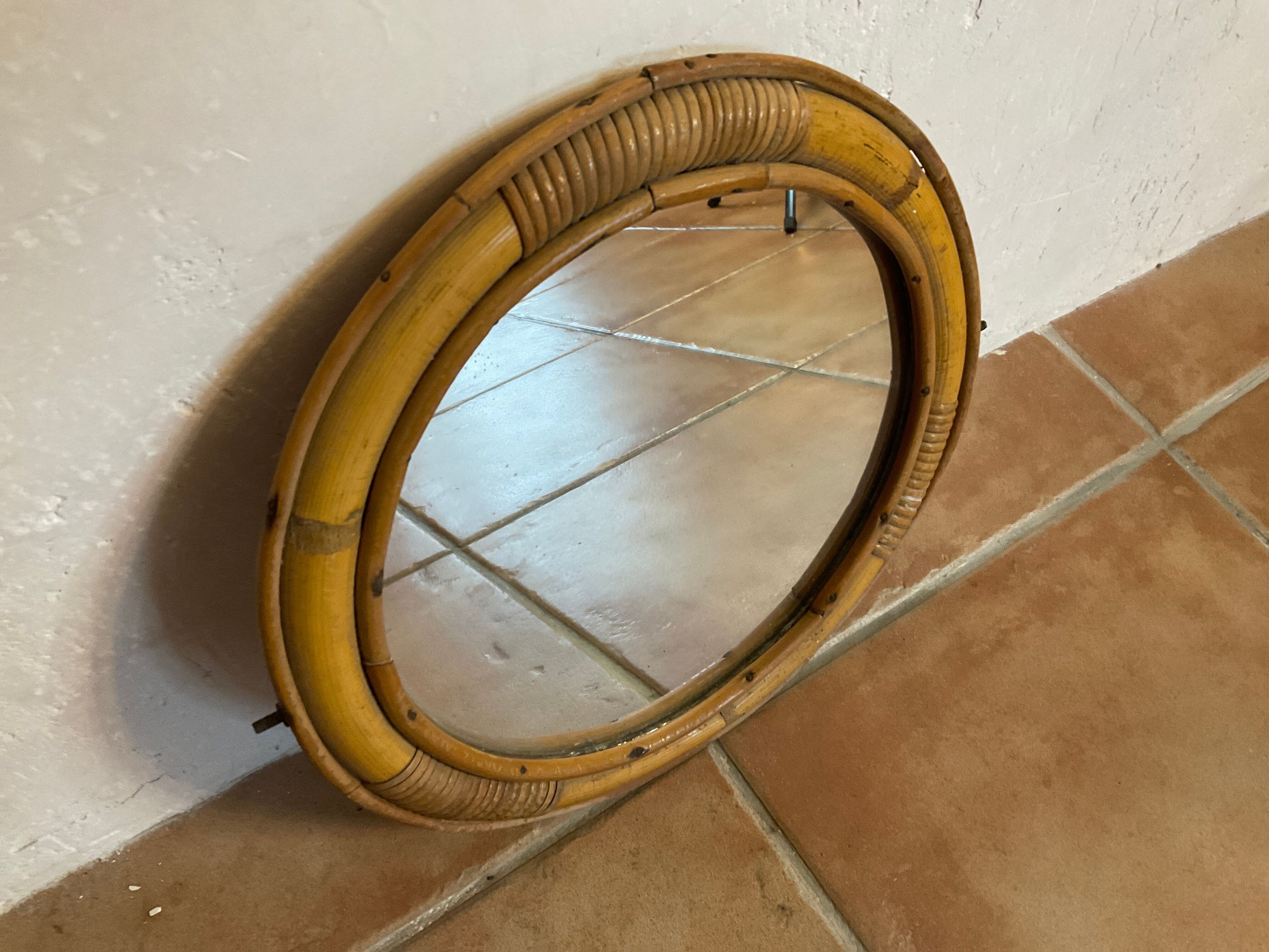 Old rattan mirror with porthole shape