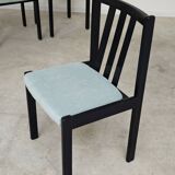 Set of 6 modernist black chairs with light blue-green ribbed fabric.