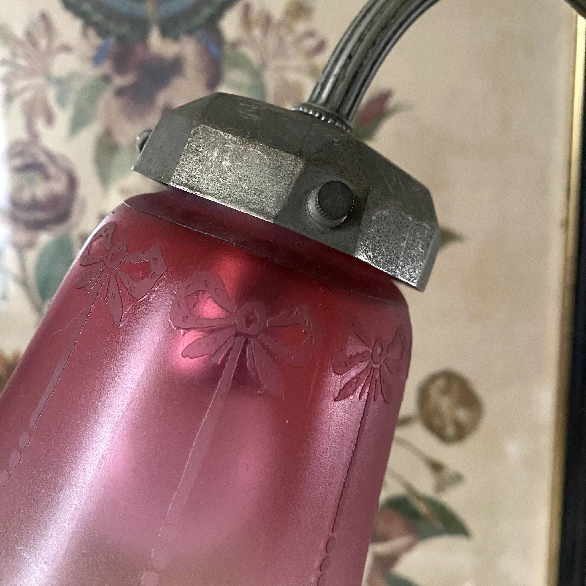 Antique jeweller's lamp, silver-plated base, frosted pink glass shade.