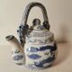 Old Chinese blue and white teapot in vintage ceramic with dragon decor